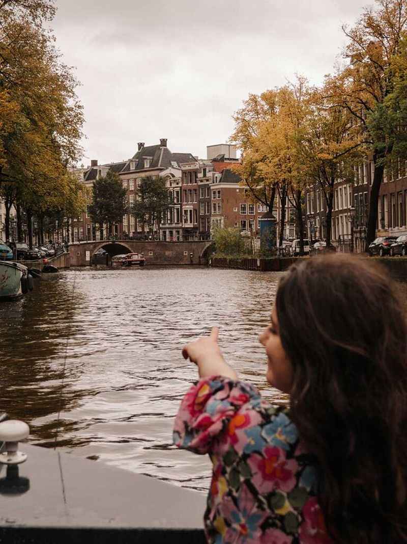 A brunette woman on a Mokum canal cruise in Amsterdam